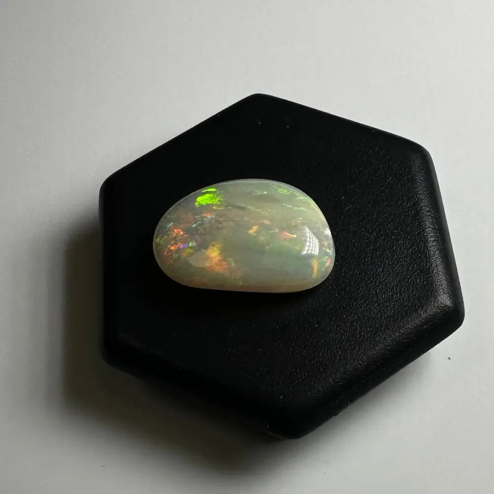 Iridescent opal cabochon displayed in Lightning Ridge Opal 2.4 carat solid hand-cut jewelry