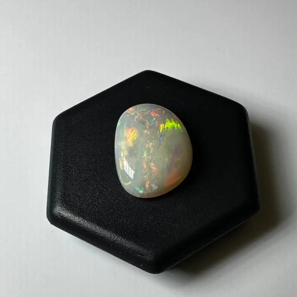 Iridescent Lightning Ridge Opal gemstone displayed in a 2.4 carat solid hand-cut jewelry piece