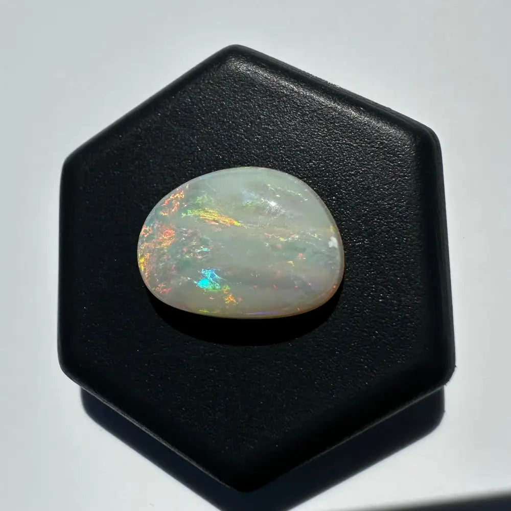 Iridescent Lightning Ridge Opal gemstone displayed in the 2.4 carat solid hand-cut product