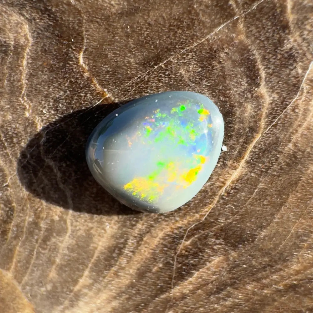 Polished Lightning Ridge Semi Black Opal with vibrant color play and hand-cut artisan craftsmanship