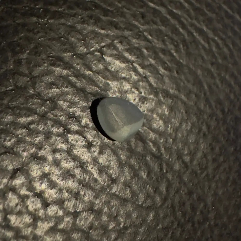 Gray makeup sponge displayed with Lightning Ridge Semi Black Opal 0.4 carat solid hand-cut gemstone
