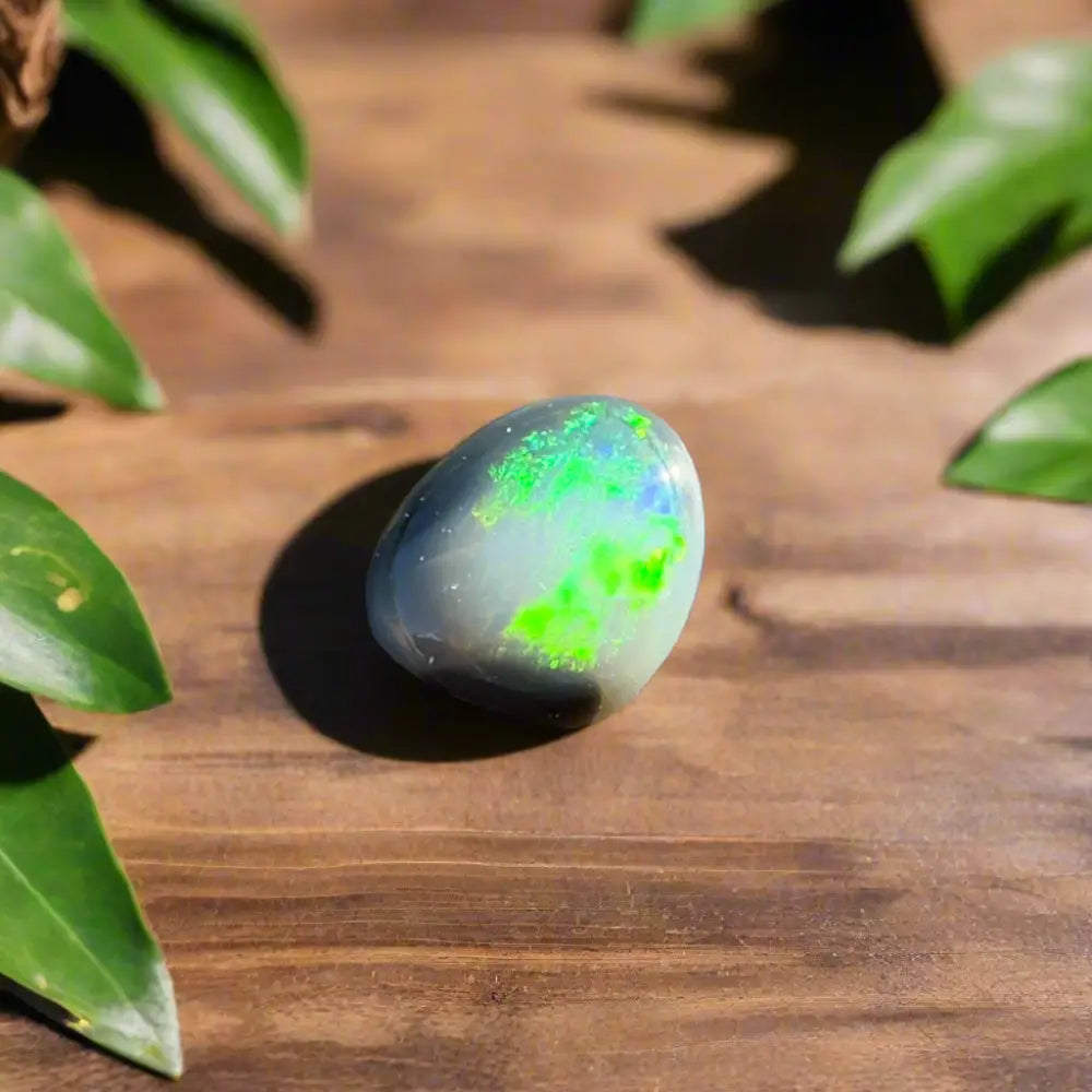 Polished Lightning Ridge Semi Black Opal 0.4 carat with green and blue play-of-color
