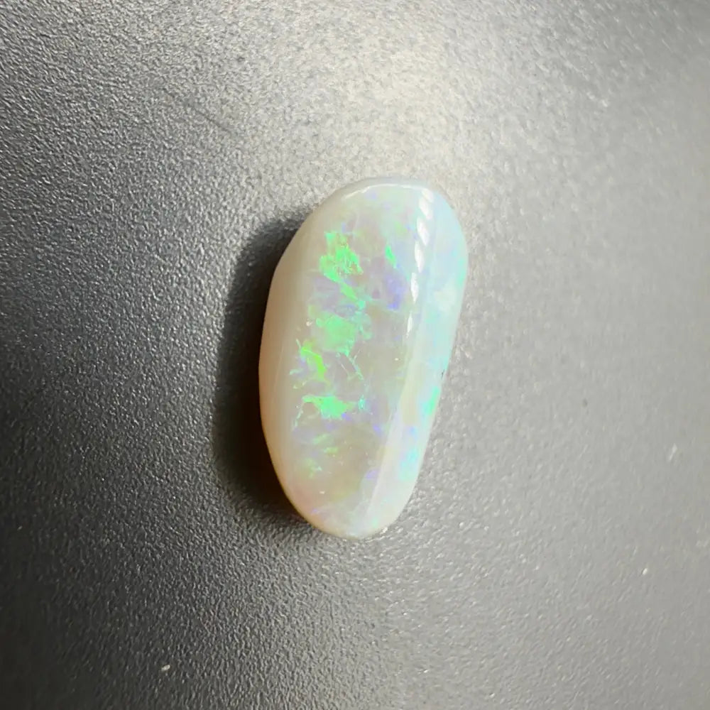 Polished white opal with striking green and blue play-of-color in Lightning Ridge Semi Black Opal 1.2carat