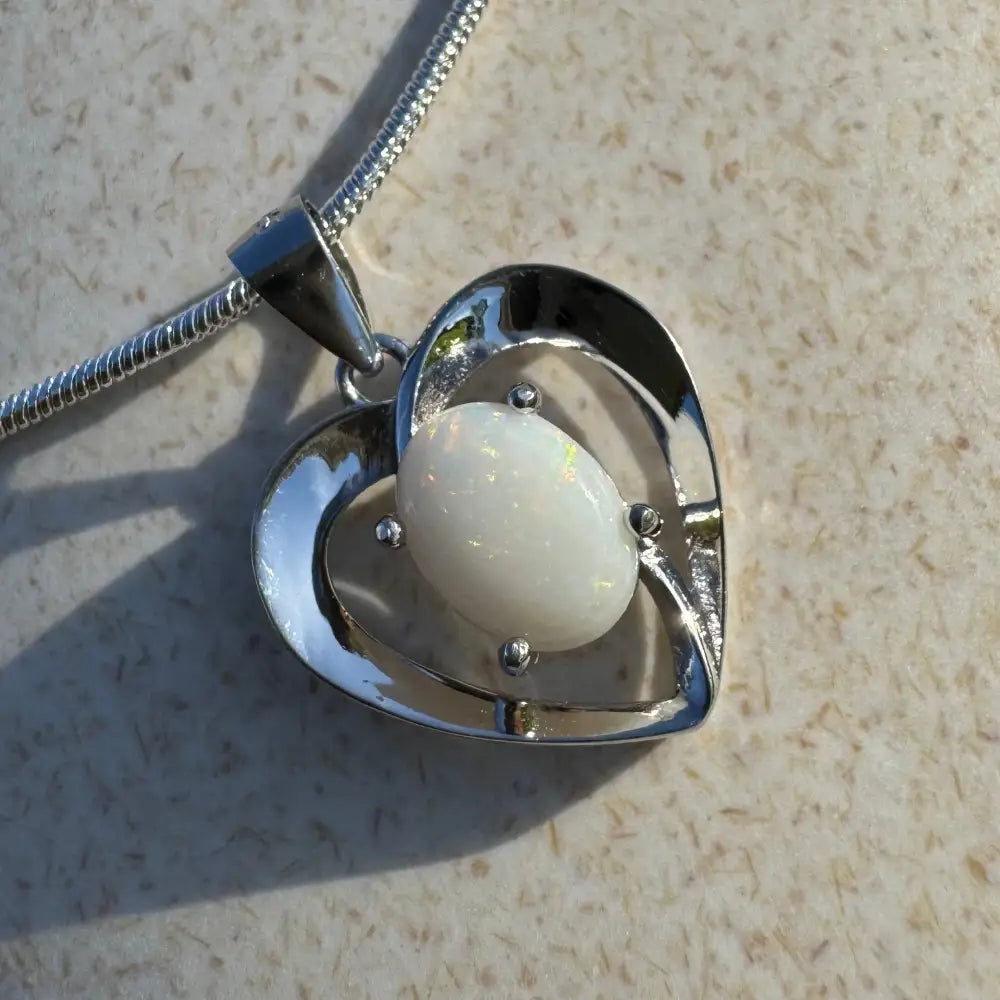 Heart-shaped opal pendant necklace showcasing handcrafted 0.9ct Coober Pedy opal in sterling silver