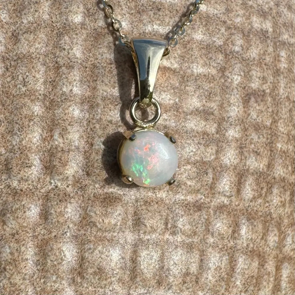 Handcrafted 9ct solid gold Opal pendant necklace featuring a 0.8ct Coober Pedy Opal in Outback Fire style