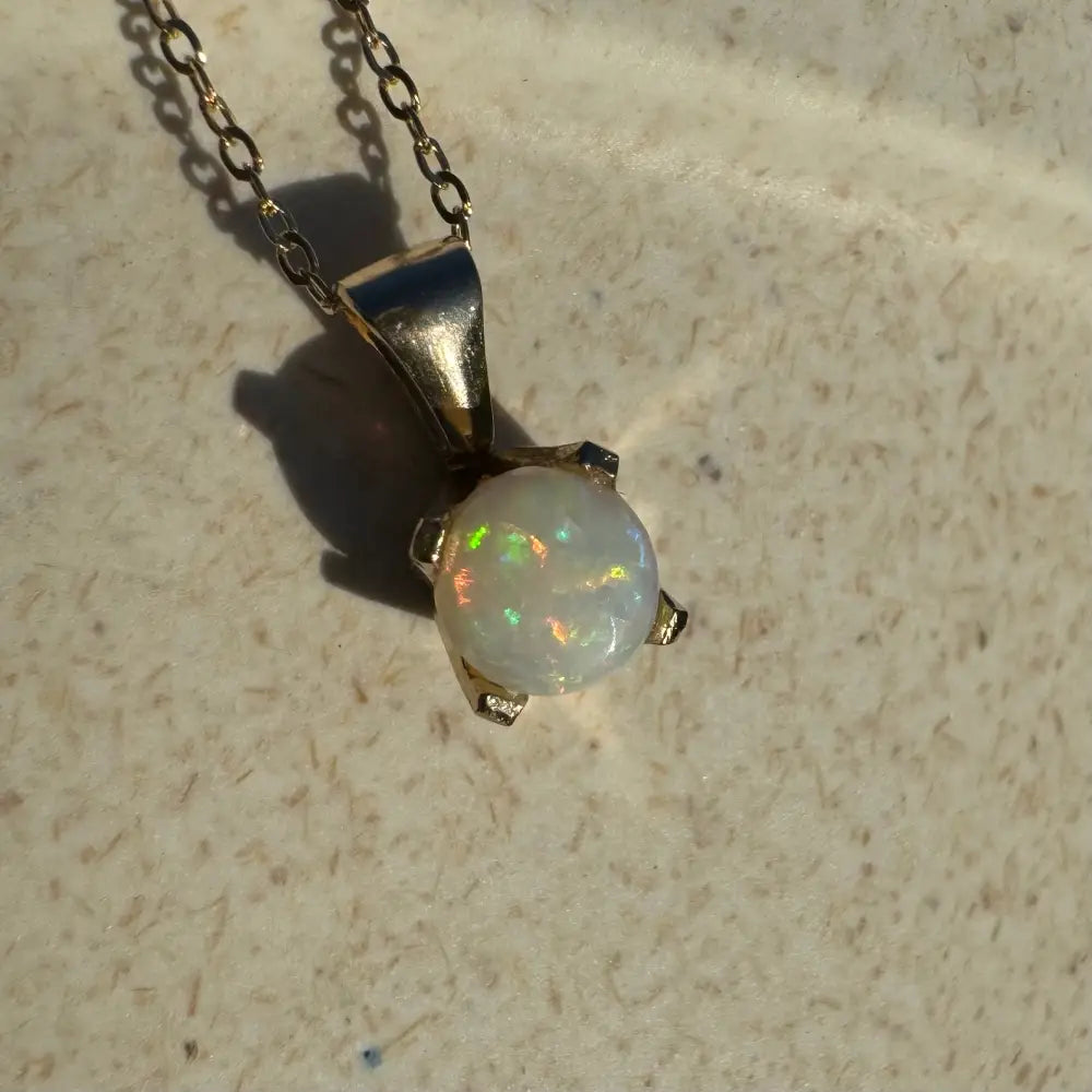 Elegant handcrafted 9ct solid gold Opal pendant necklace featuring a 0.8ct Coober Pedy Opal