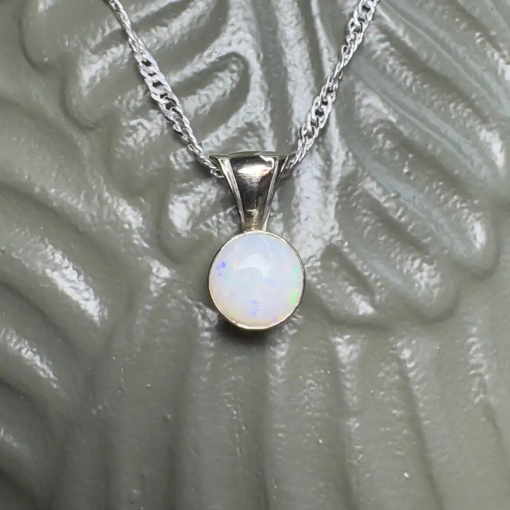 Silver necklace with opal pendant.