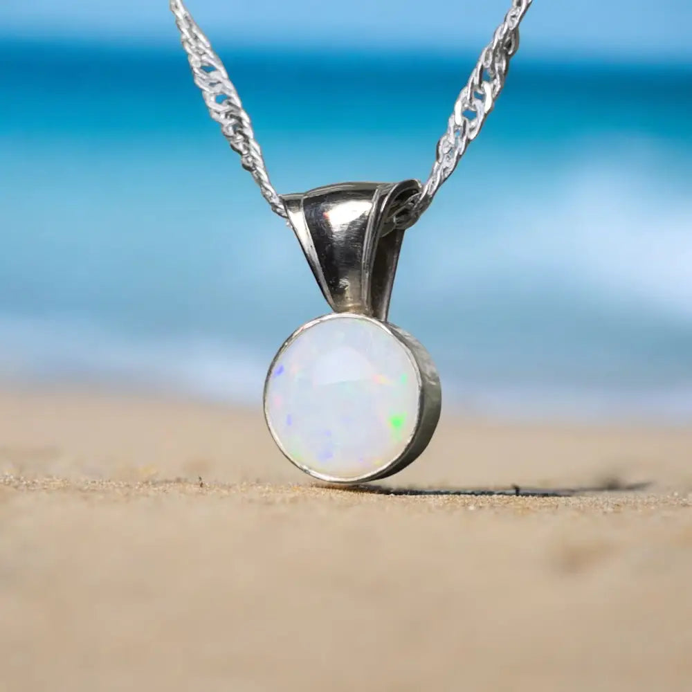 Silver chain opal pendant.