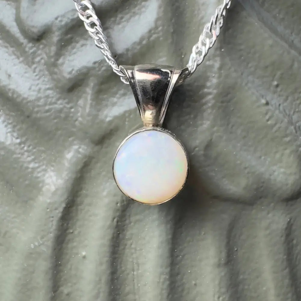 Silver necklace with opal pendant.