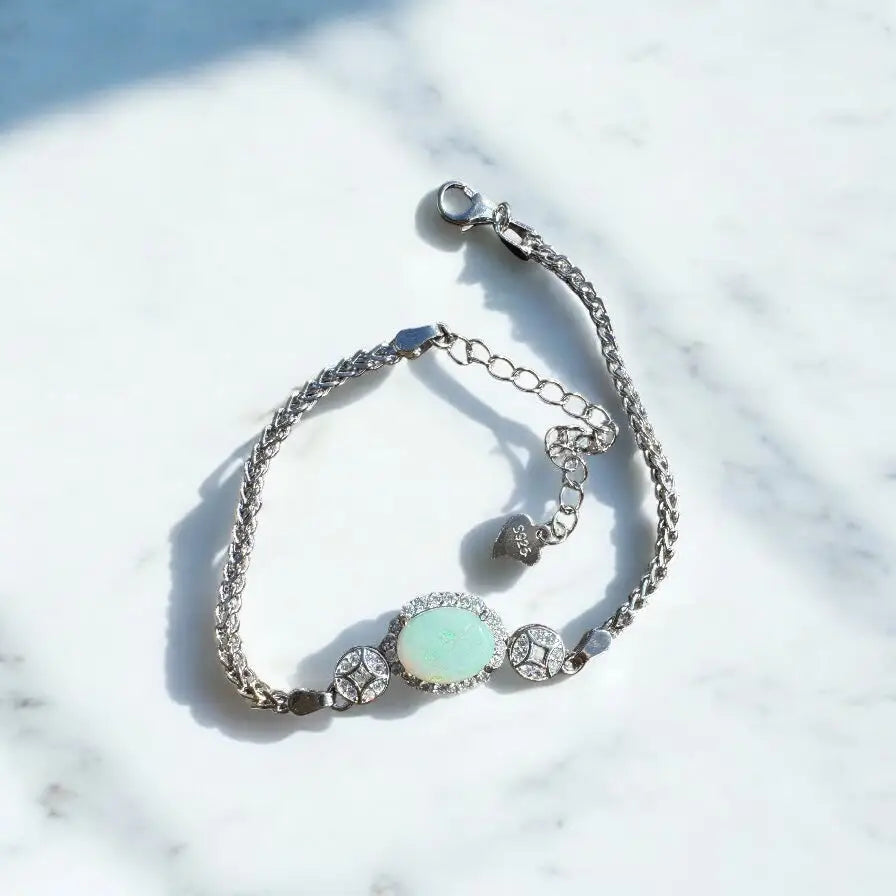 Silver bracelet featuring a 1.4-carat Coober Pedy Opal center stone and cubic zirconia accents