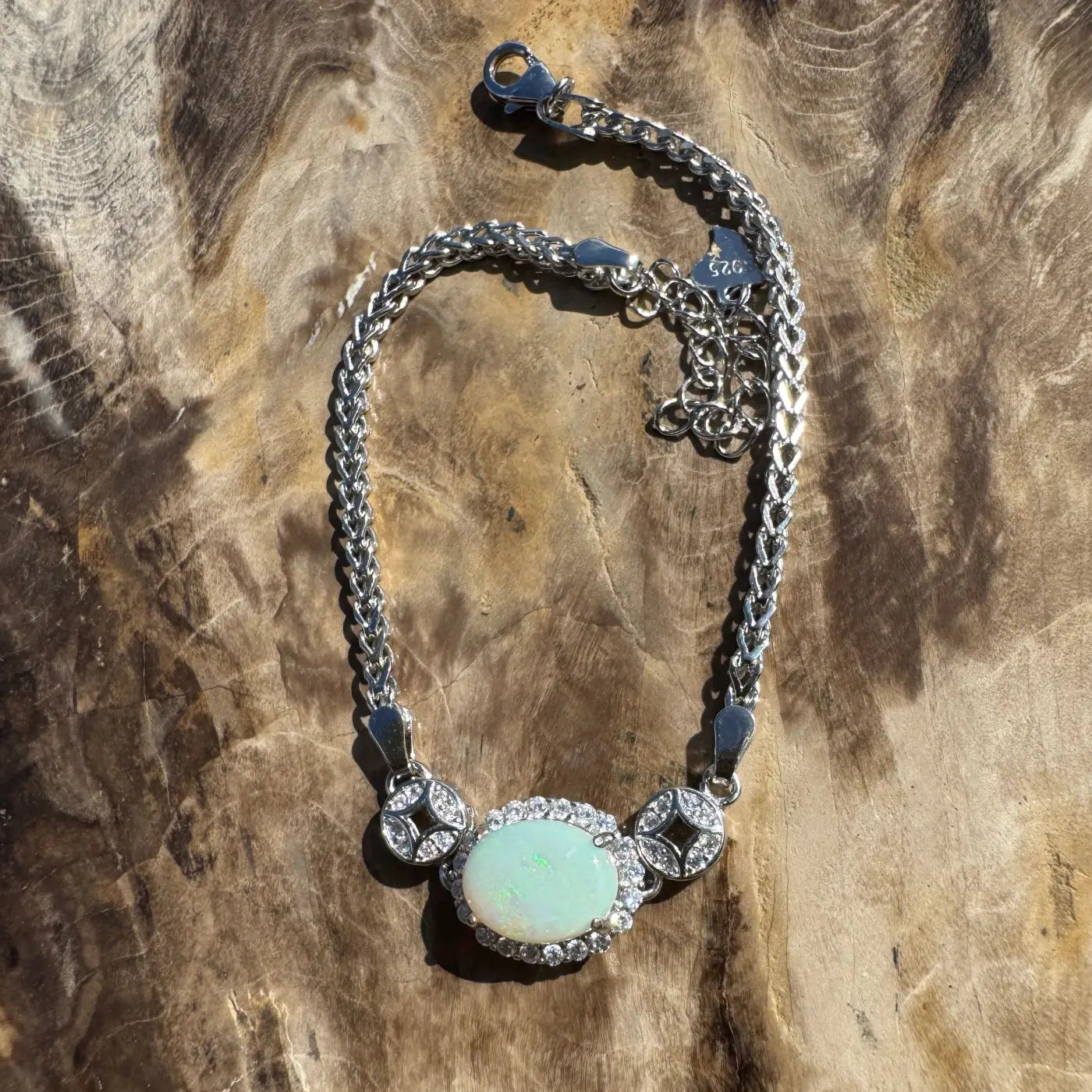 Silver opal necklace featuring a handcrafted rainforests-inspired design with Coober Pedy opal