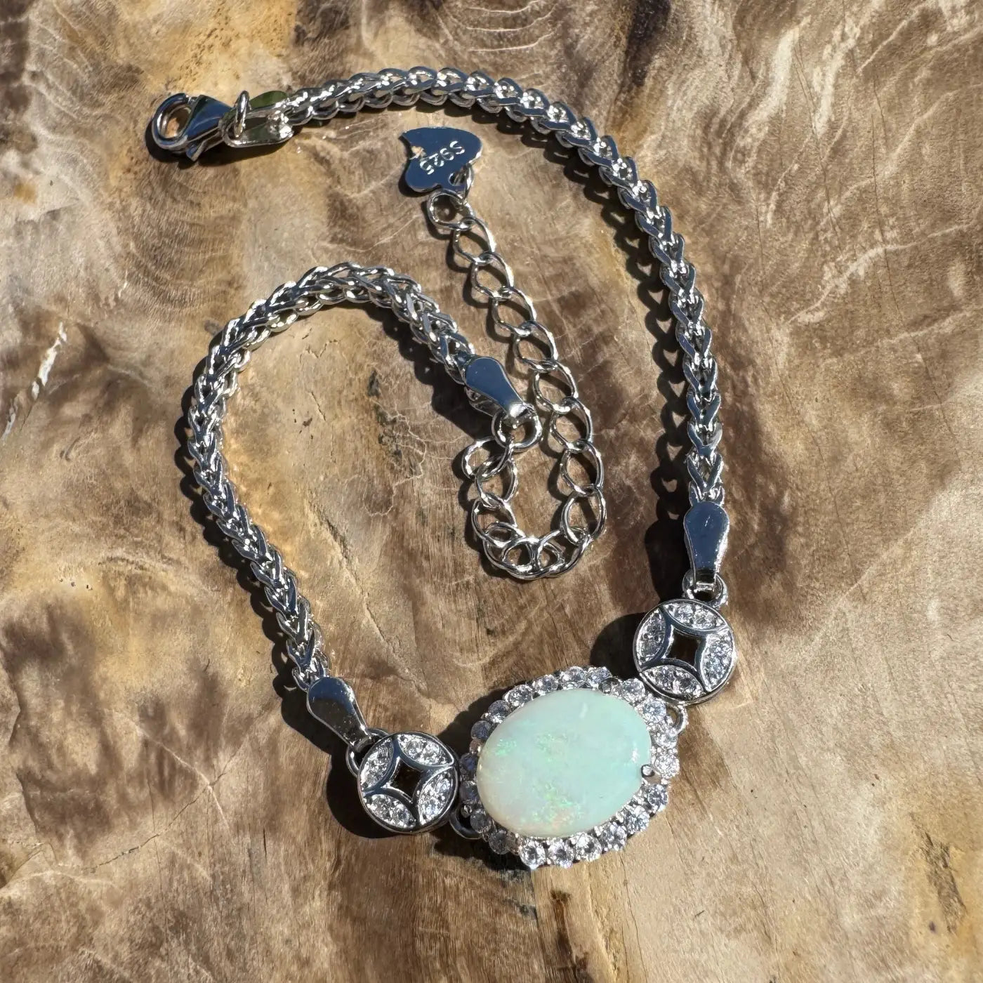 Silver bracelet with Coober Pedy opal and diamond accents in handcrafted design