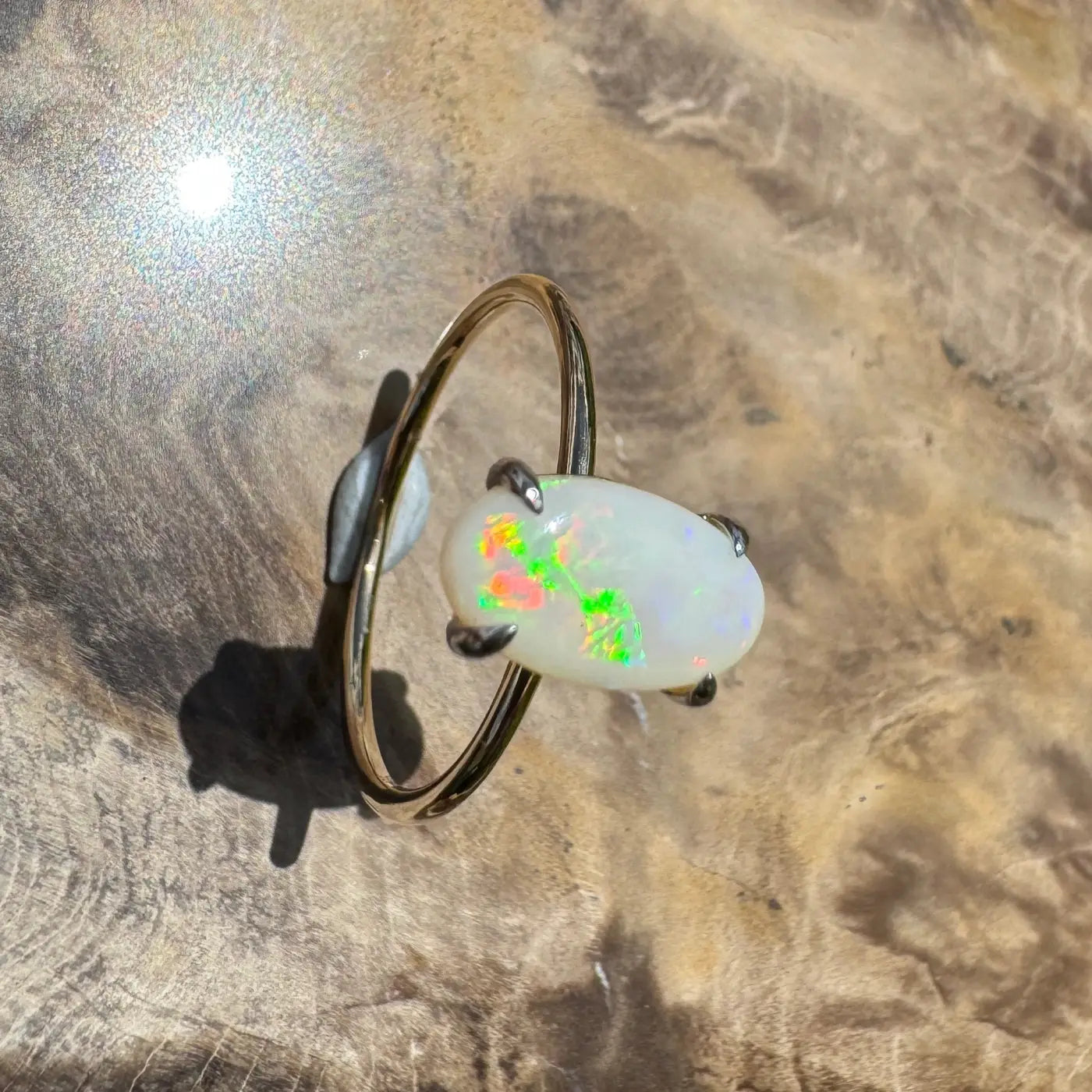Opal gemstone ring with colorful play-of-color in yellow gold handcrafted jewelry