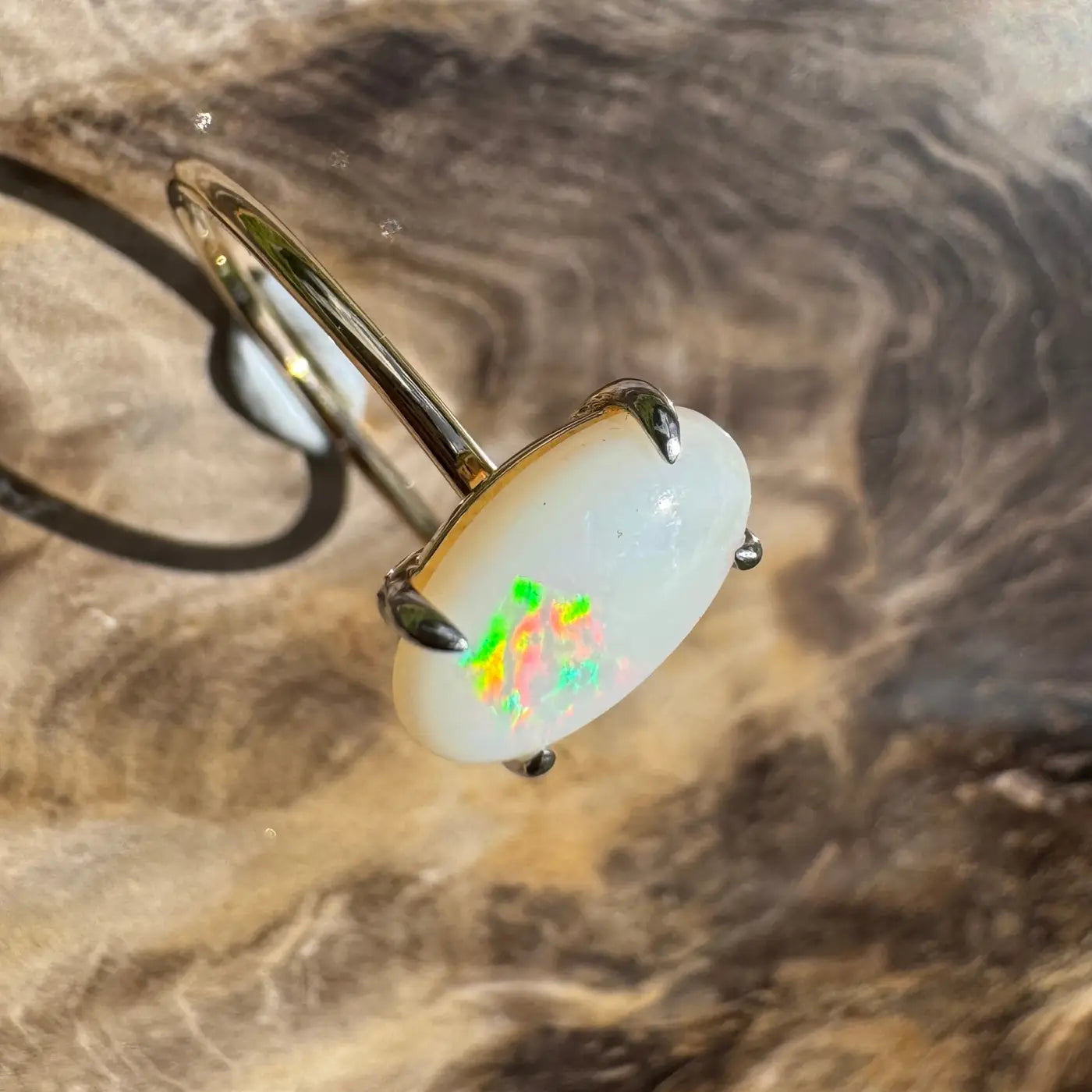 Oval opal ring with vibrant colorful flashes in handcrafted Coober Pedy opal and 9ct yellow gold