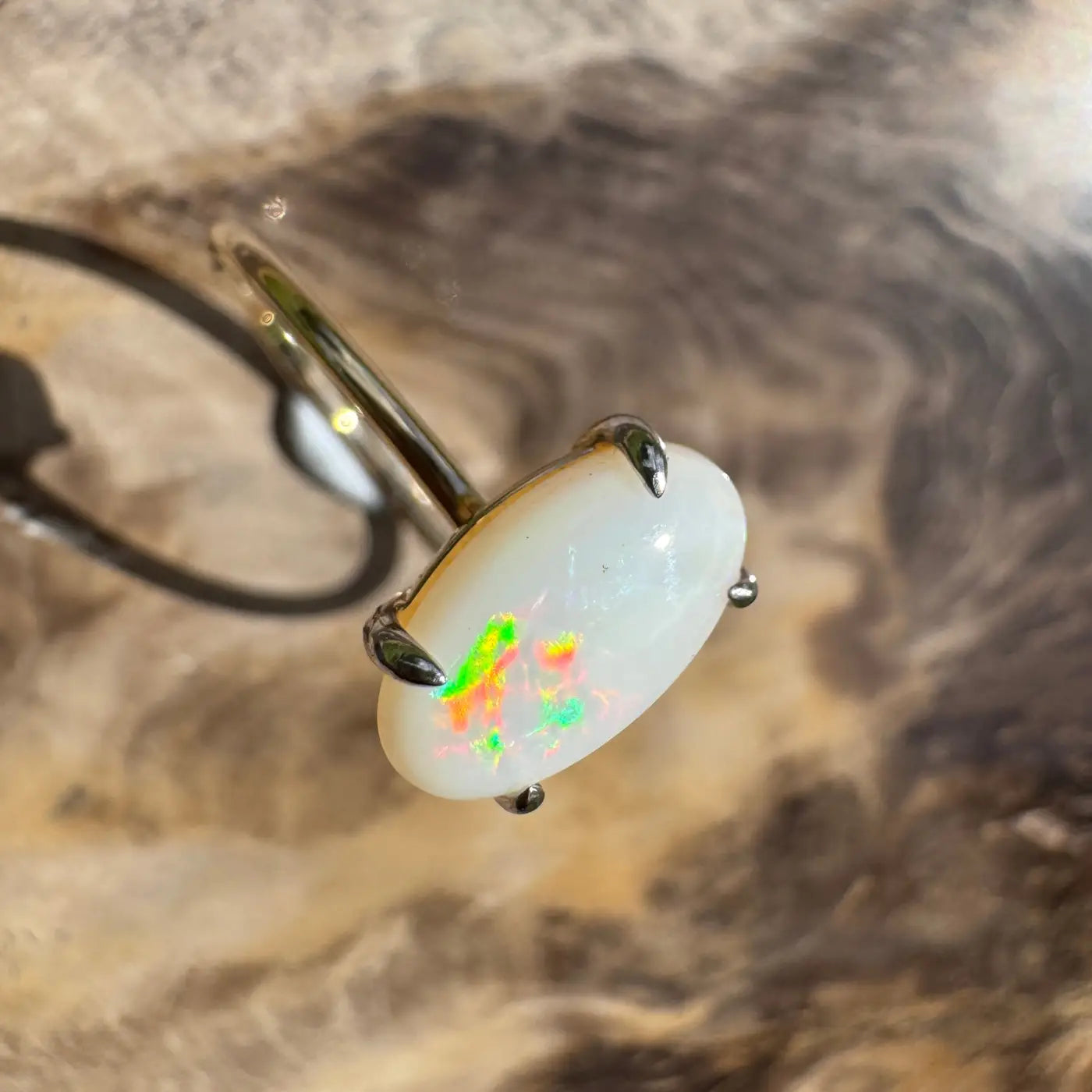 Oval opal ring with claw prongs from the Rolling Colours of Coober collection in 9ct yellow gold