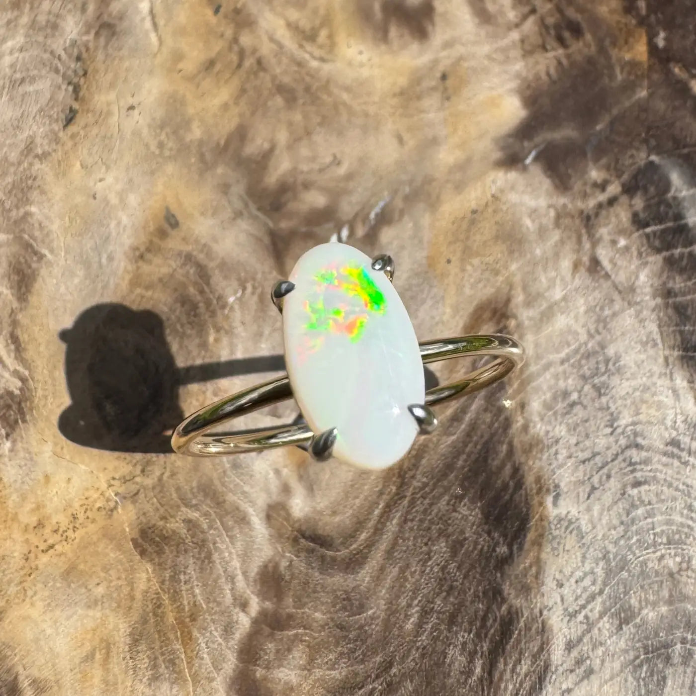 Opal ring with silver band featuring a 0.9ct Coober Pedy Opal in yellow gold setting