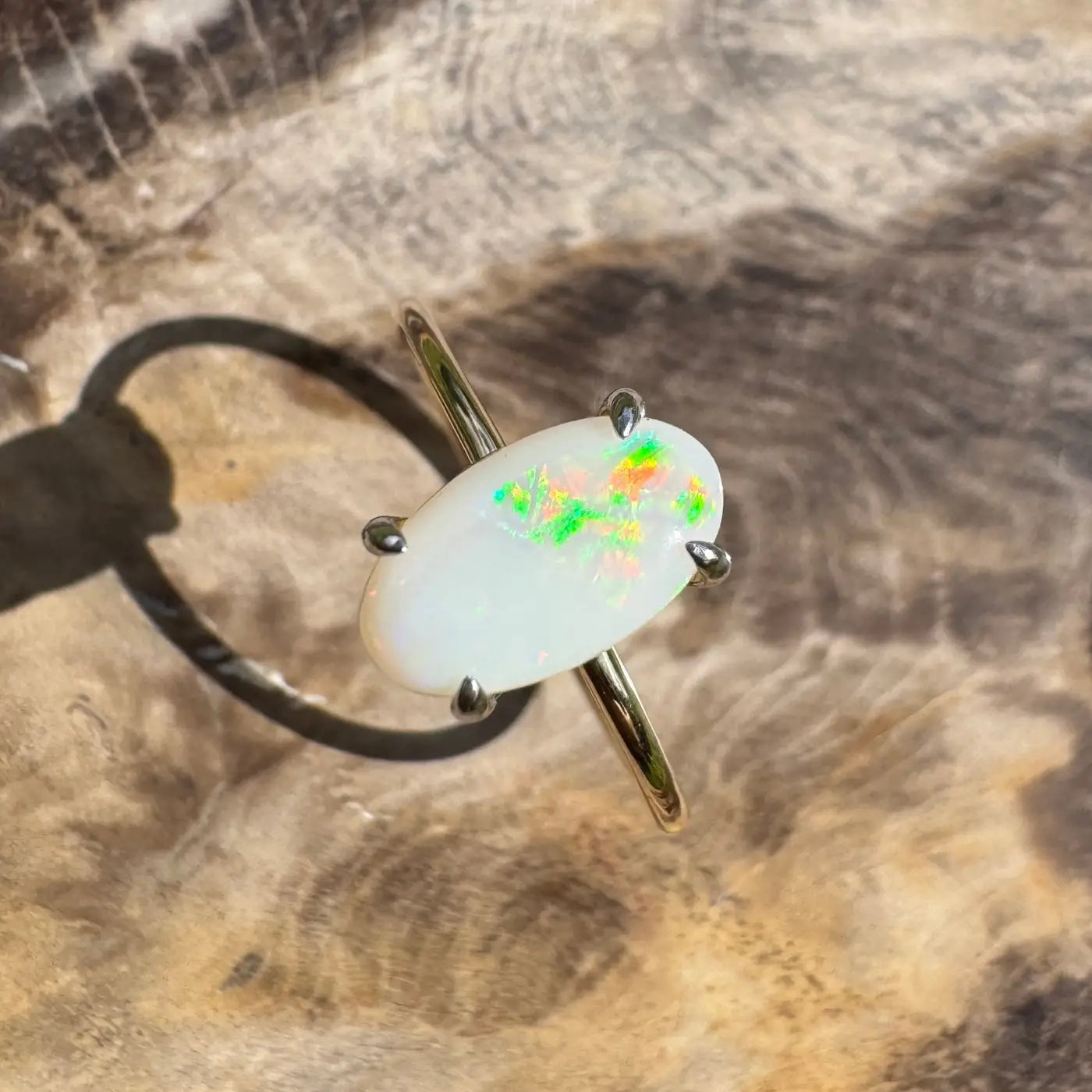 Oval opal ring with vibrant colorful flashes in handcrafted 9ct yellow gold design