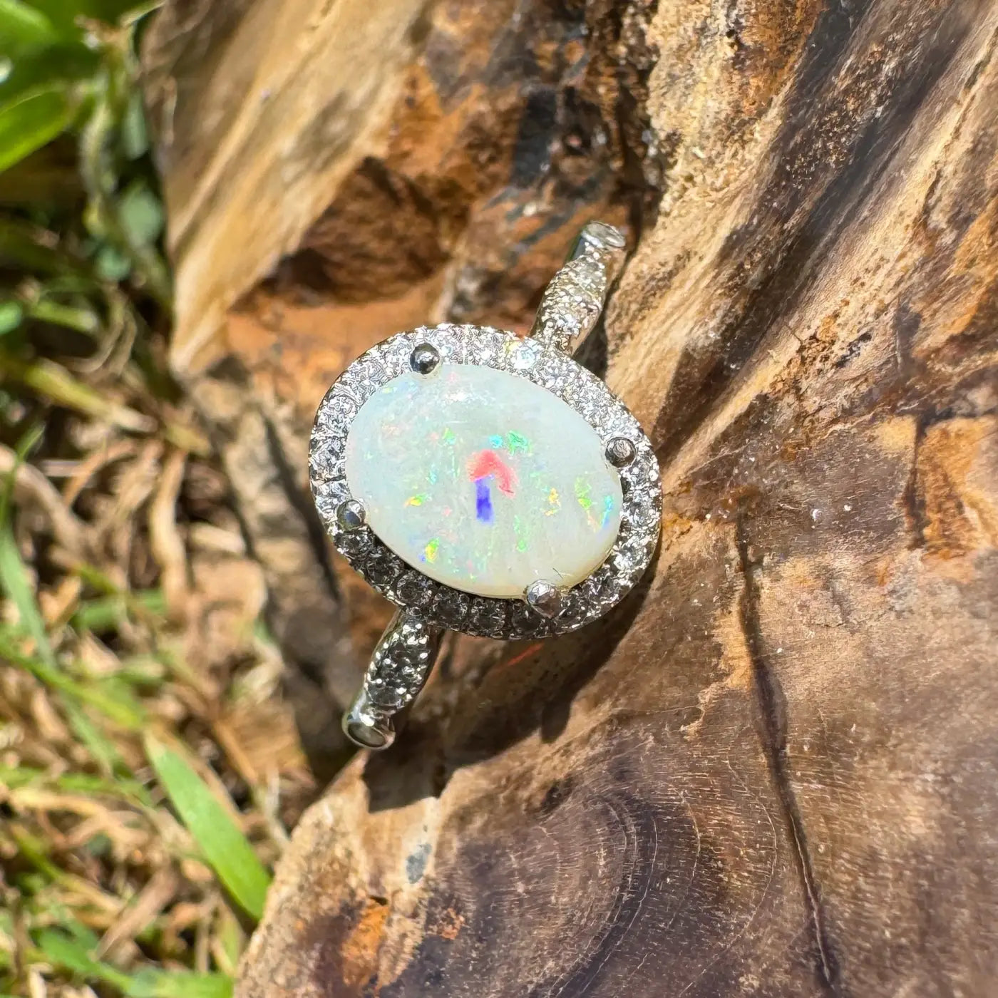 Oval opal ring with diamond halo in handcrafted 925 sterling silver featuring Coober Pedy opal