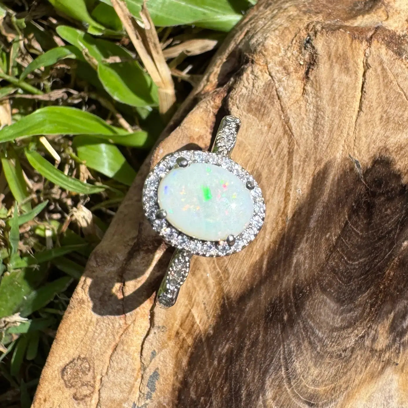 Elegant oval opal ring with diamond halo from Snowy Peaks handcrafted sterling silver jewelry