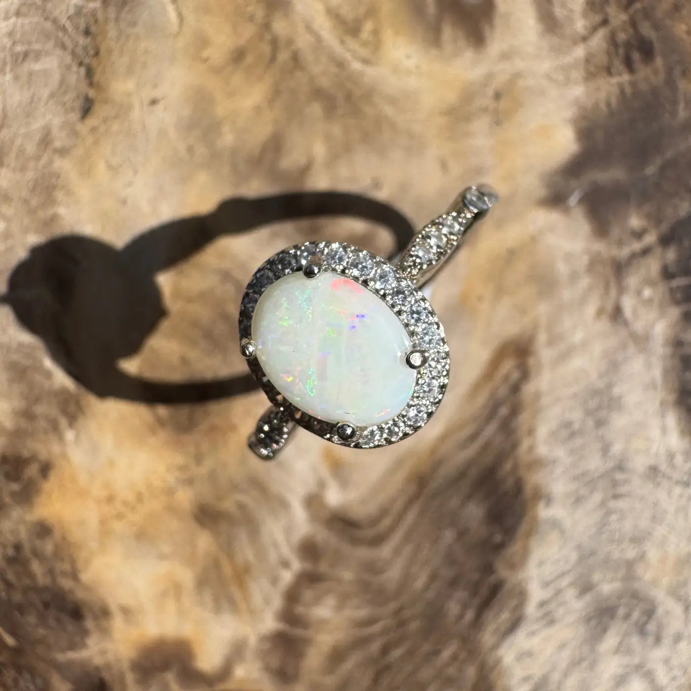 Oval opal ring with diamond halo from Snowy Peaks handcrafted sterling silver jewelry