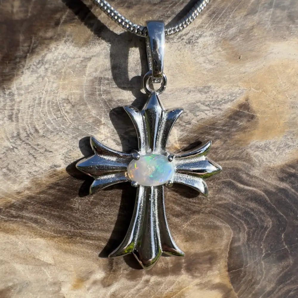 Silver cross pendant with opal.