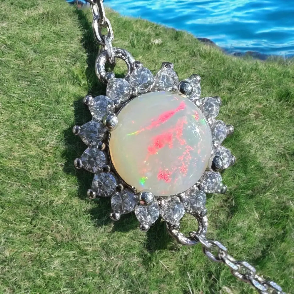 Opal pendant with diamond halo.