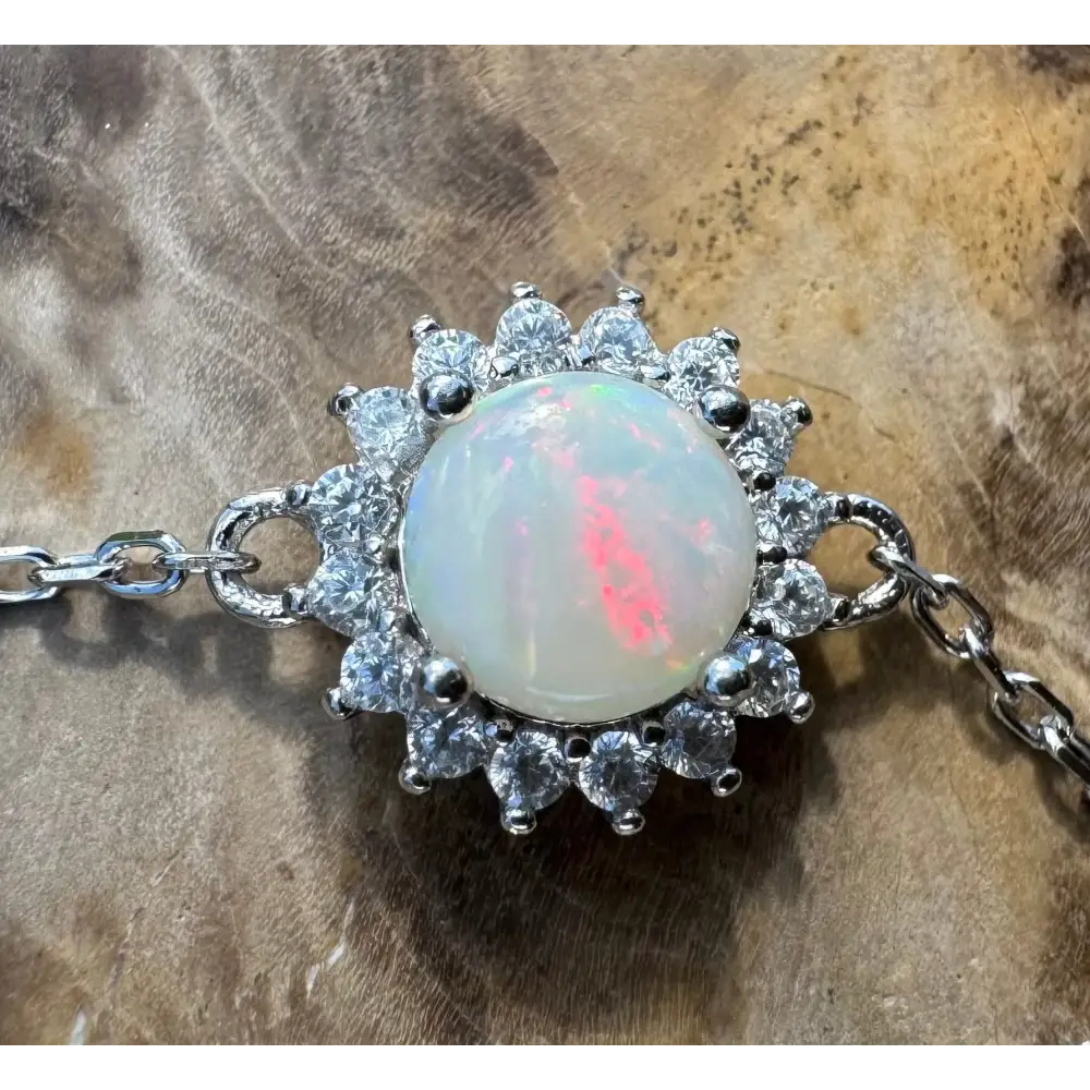 Opal gemstone bracelet with diamond halo.