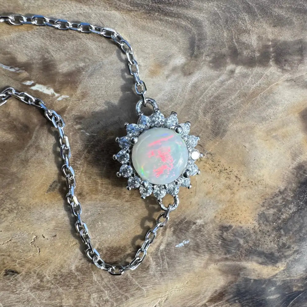 Silver chain necklace with opal and diamond pendant.