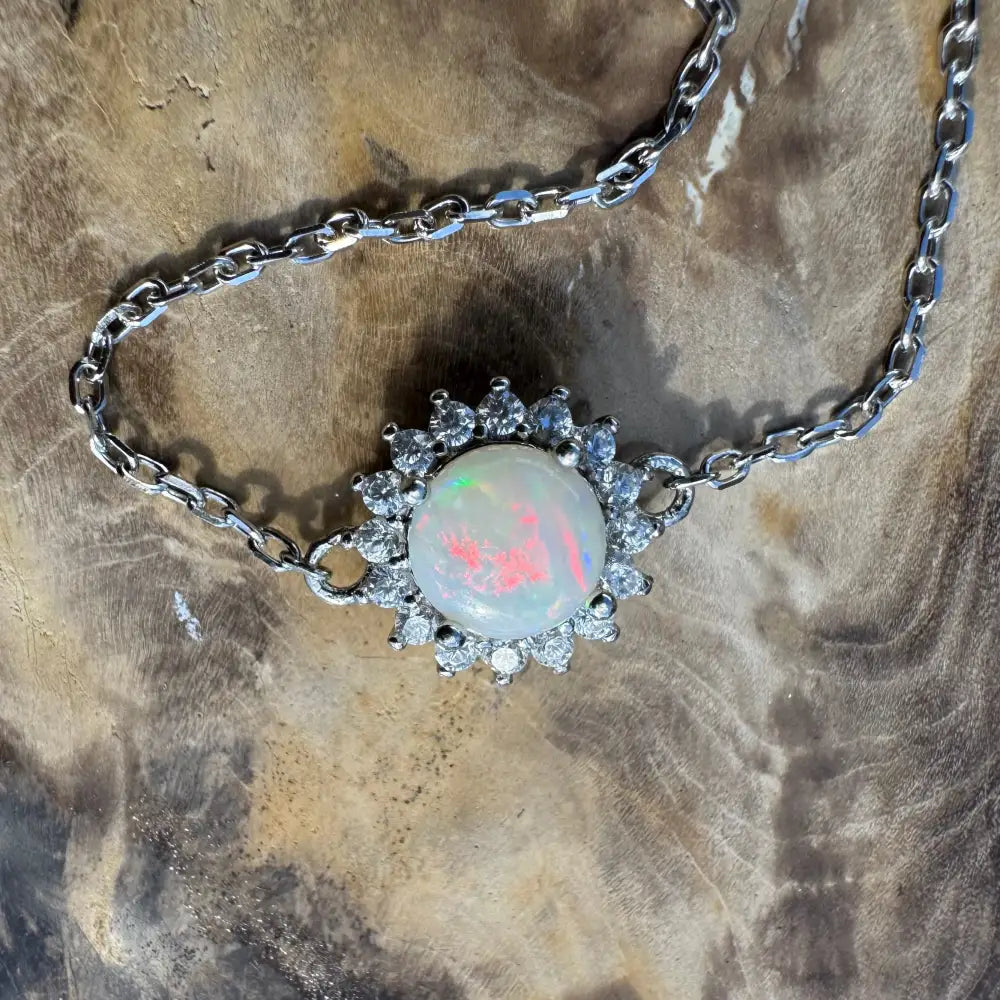 Opal pendant necklace with diamond halo.