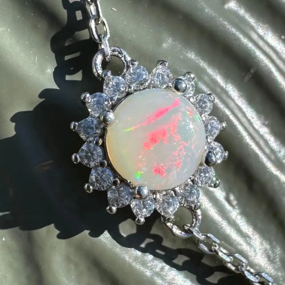Opal pendant with diamond halo.