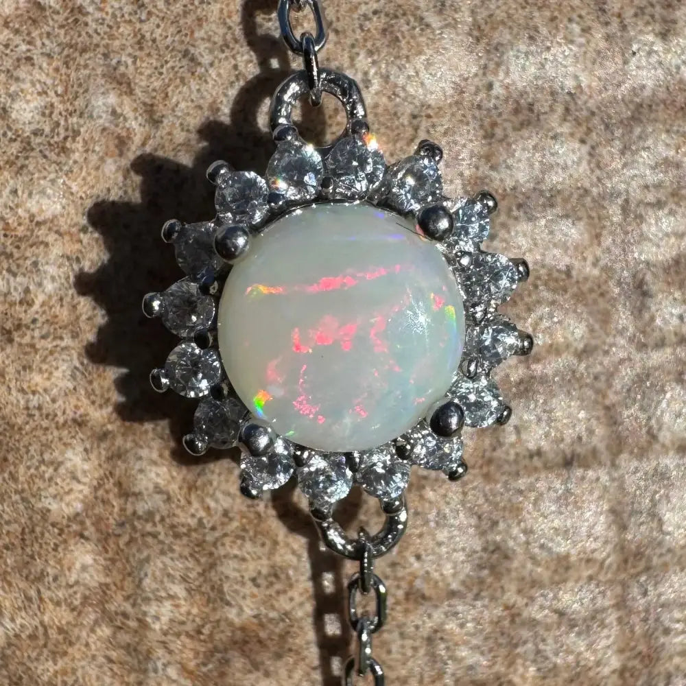 Opal pendant with diamond halo.