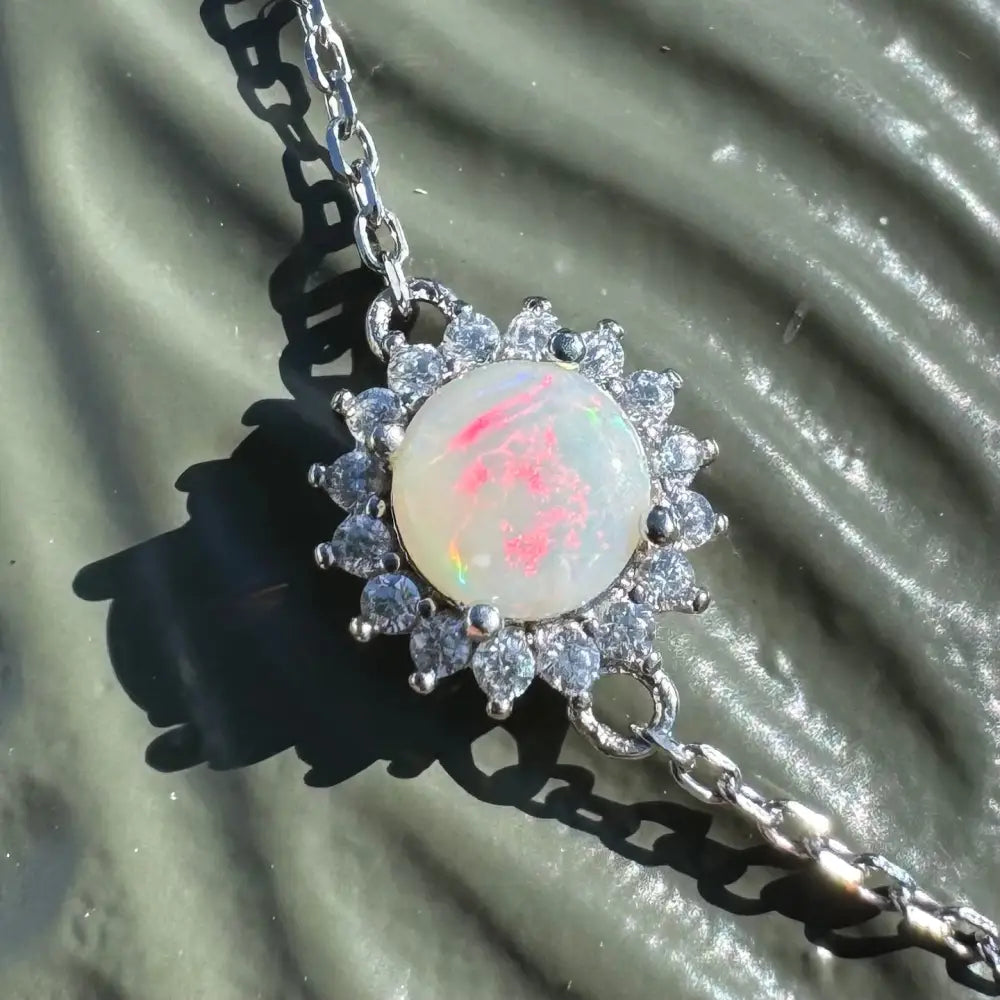 Opal pendant necklace with diamond halo.