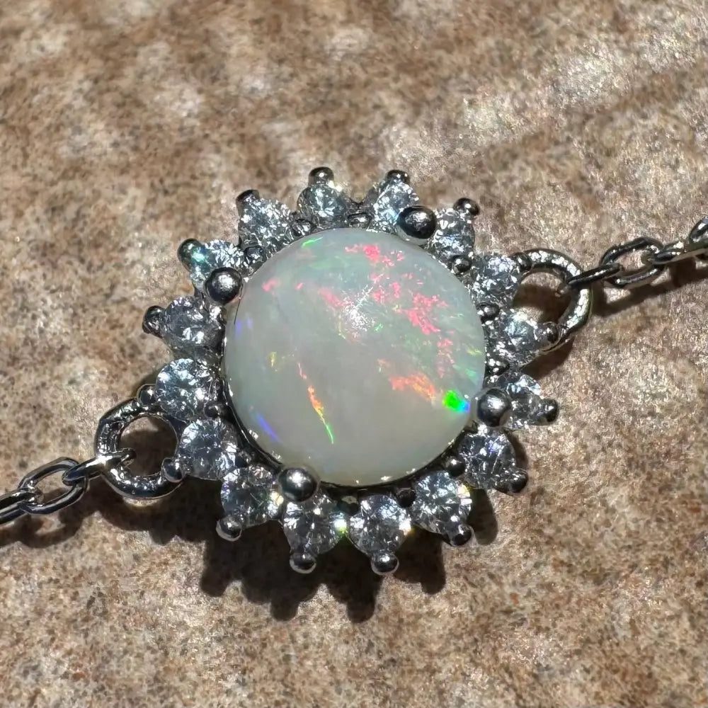 Opal and diamond halo pendant.