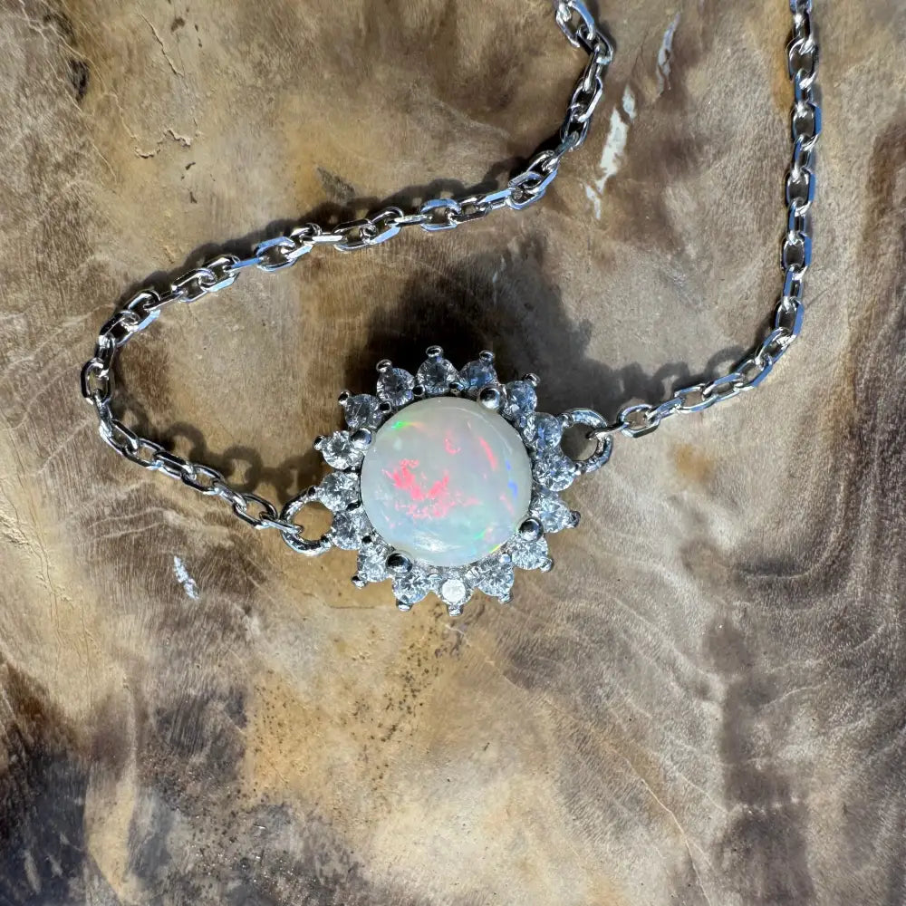Silver chain necklace with opal gemstone.