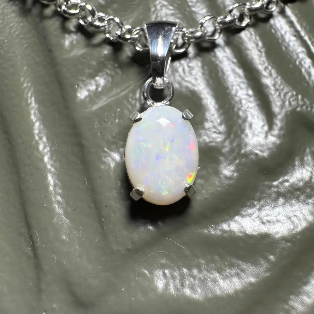 Oval Coober Pedy opal pendant on silver chain in Three Sisters Shine necklace