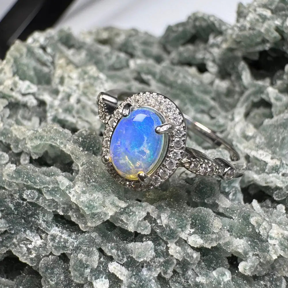 Handcrafted Wave Rock Grace ring featuring a 0.8ct Lightning Ridge Opal with diamond halo in sterling silver