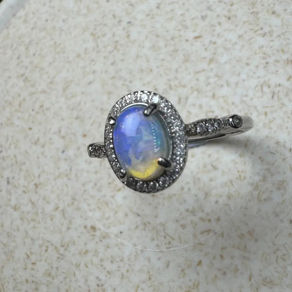 Handcrafted Wave Rock Grace ring featuring a 0.8ct Lightning Ridge Opal with diamond halo in sterling silver