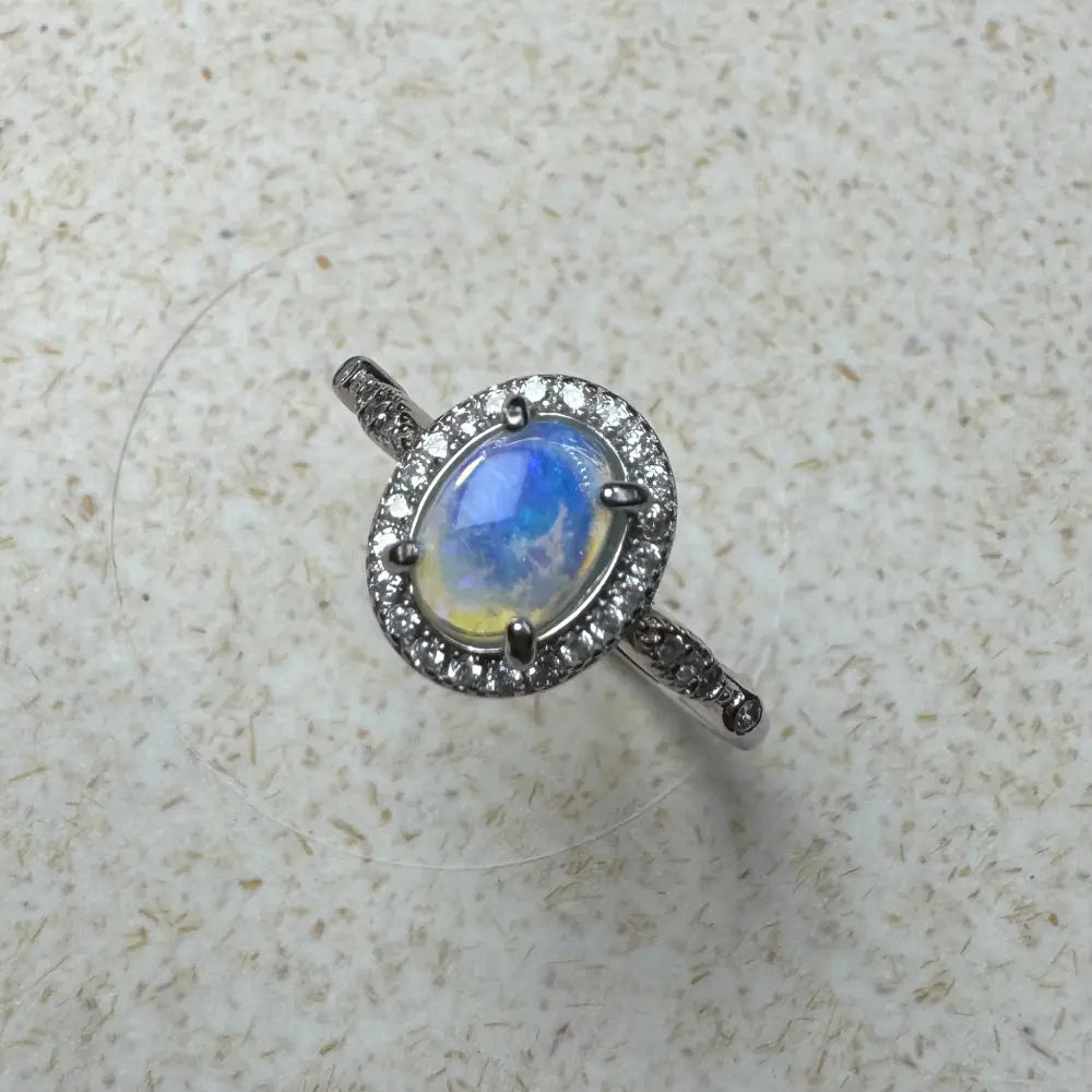 Opal ring with diamond halo featuring a 0.8ct Lightning Ridge Opal in sterling silver