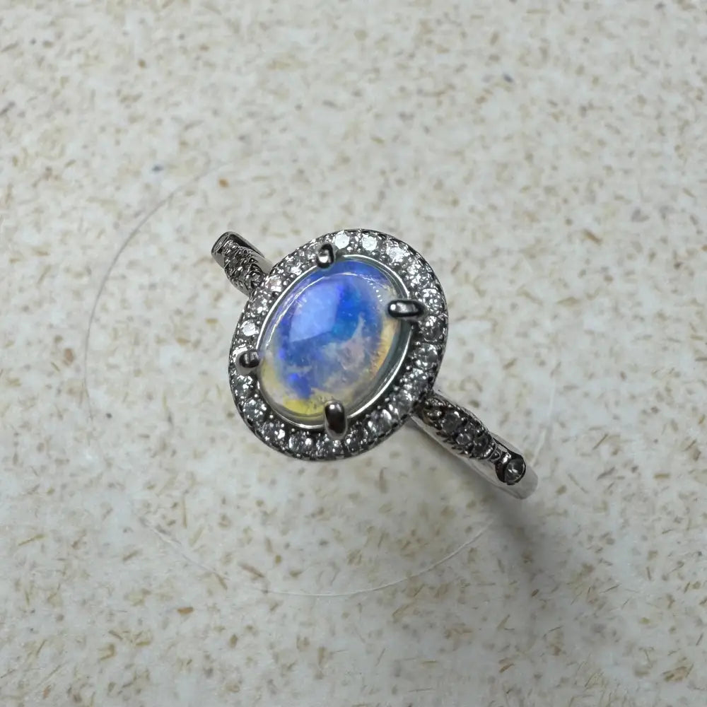 Oval moonstone ring with diamond halo in sterling silver from Wave Rock Grace collection