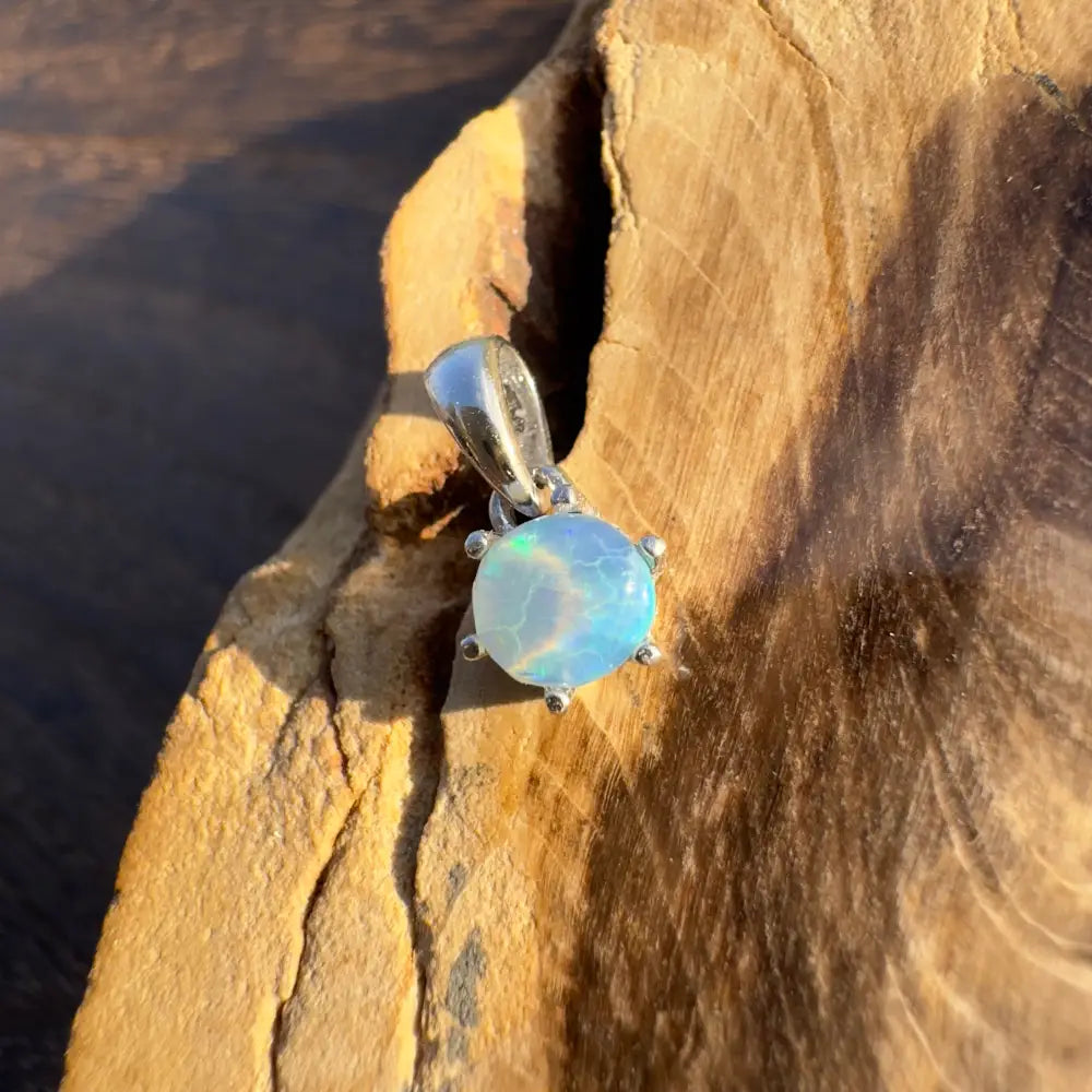 Round opal pendant with silver setting from Whale’s Journey handcrafted Lightning Ridge crystal opal collection