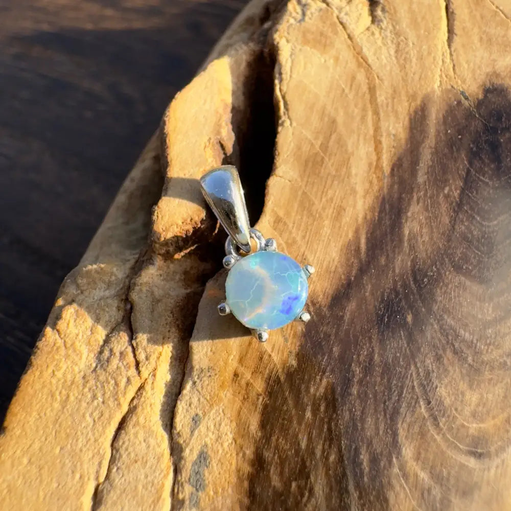 Round opal pendant with silver setting from Whale’s Journey handcrafted Lightning Ridge Crystal Opal collection