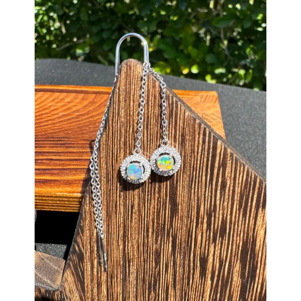 Silver opal halo earrings featuring a 0.7ct Lightning Ridge opal and cubic zirconia accents