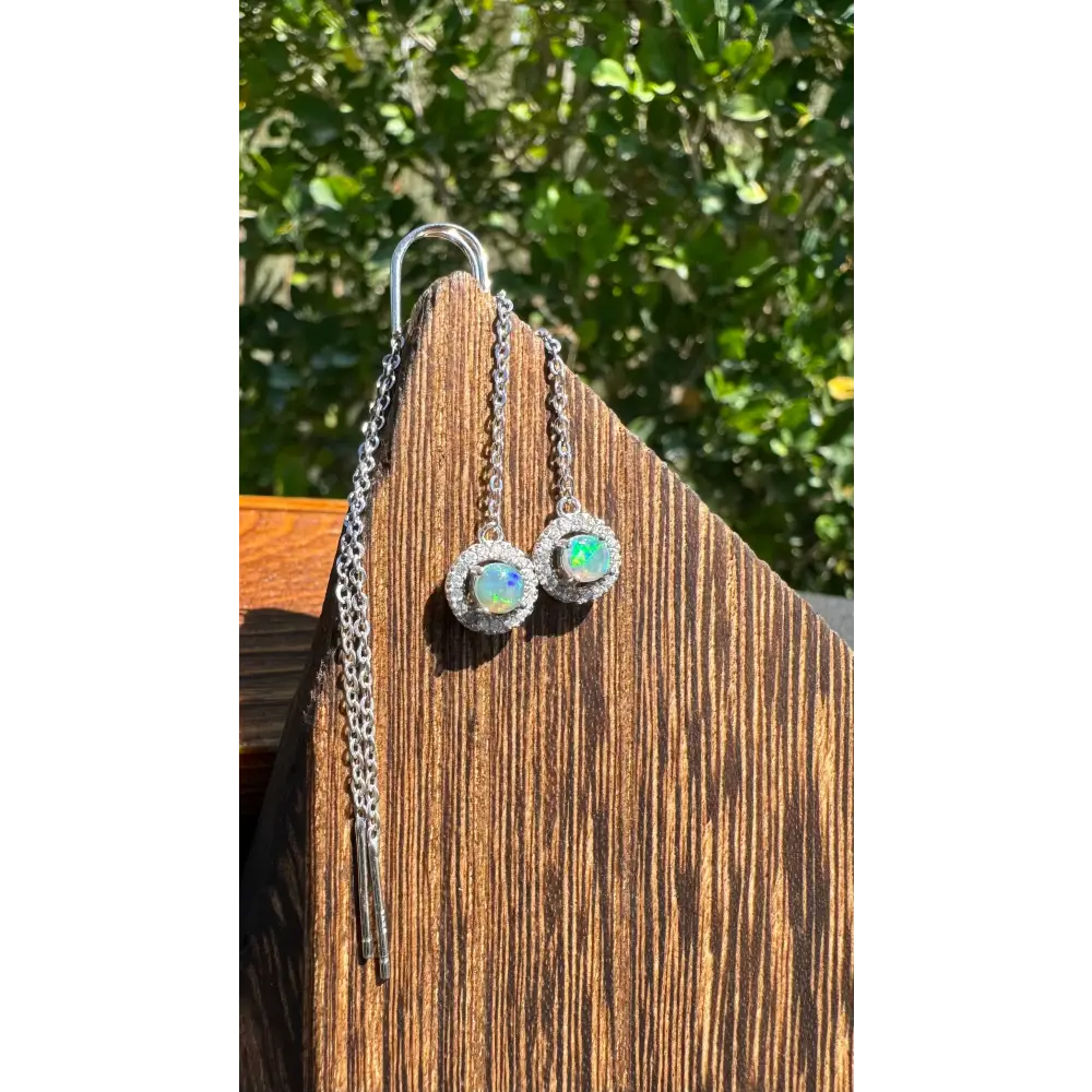 Opal halo drop earrings featuring a 0.7ct Lightning Ridge Opal and cubic zirconia design