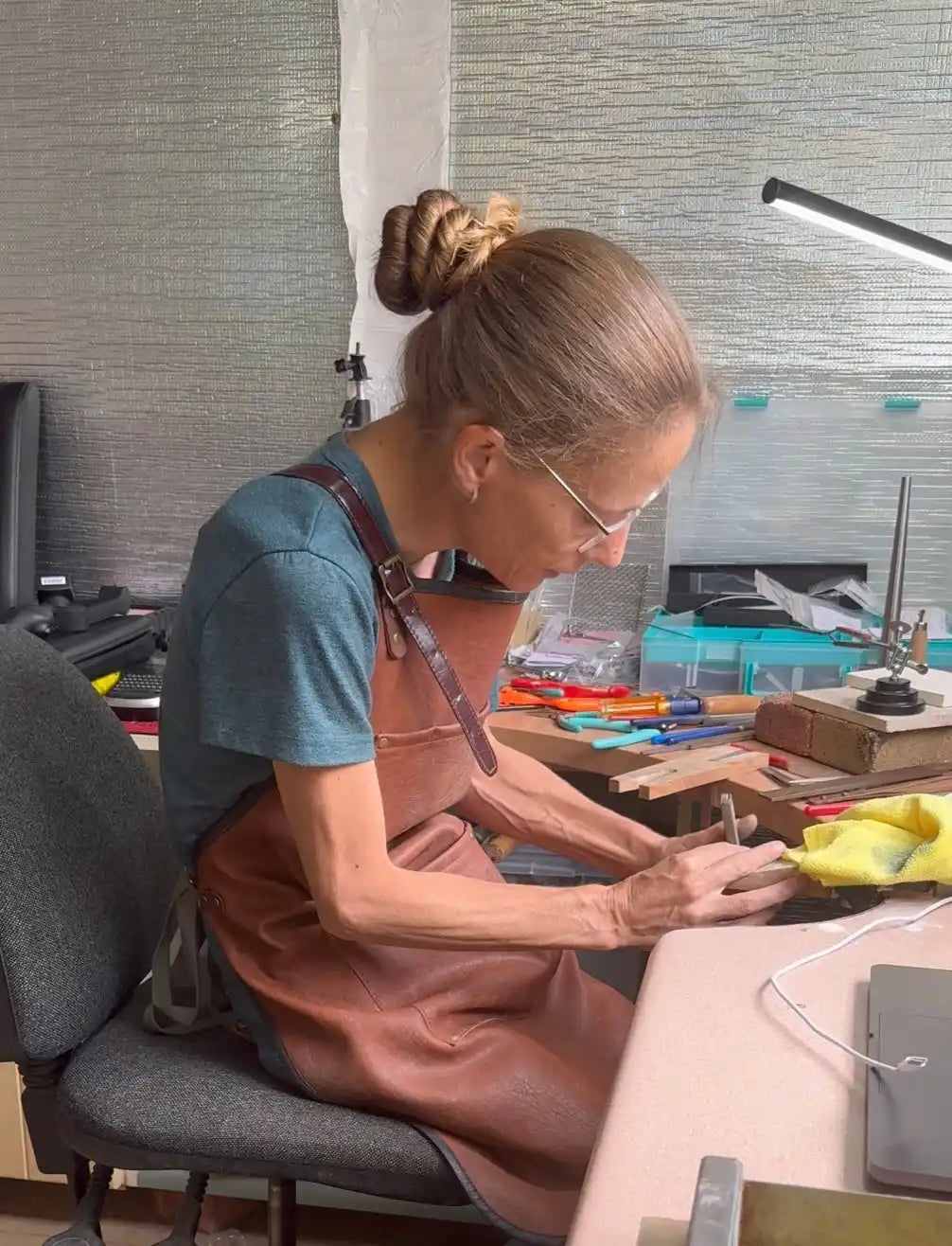 Woman working at a jewelry bench.