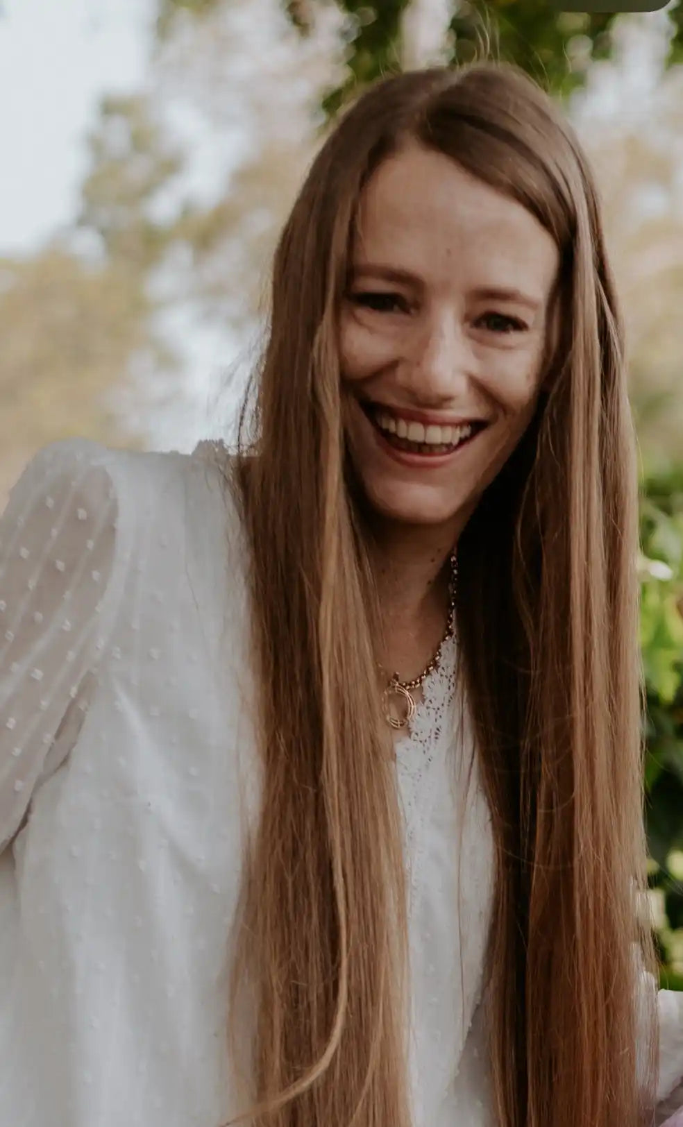 Smiling woman with long hair.