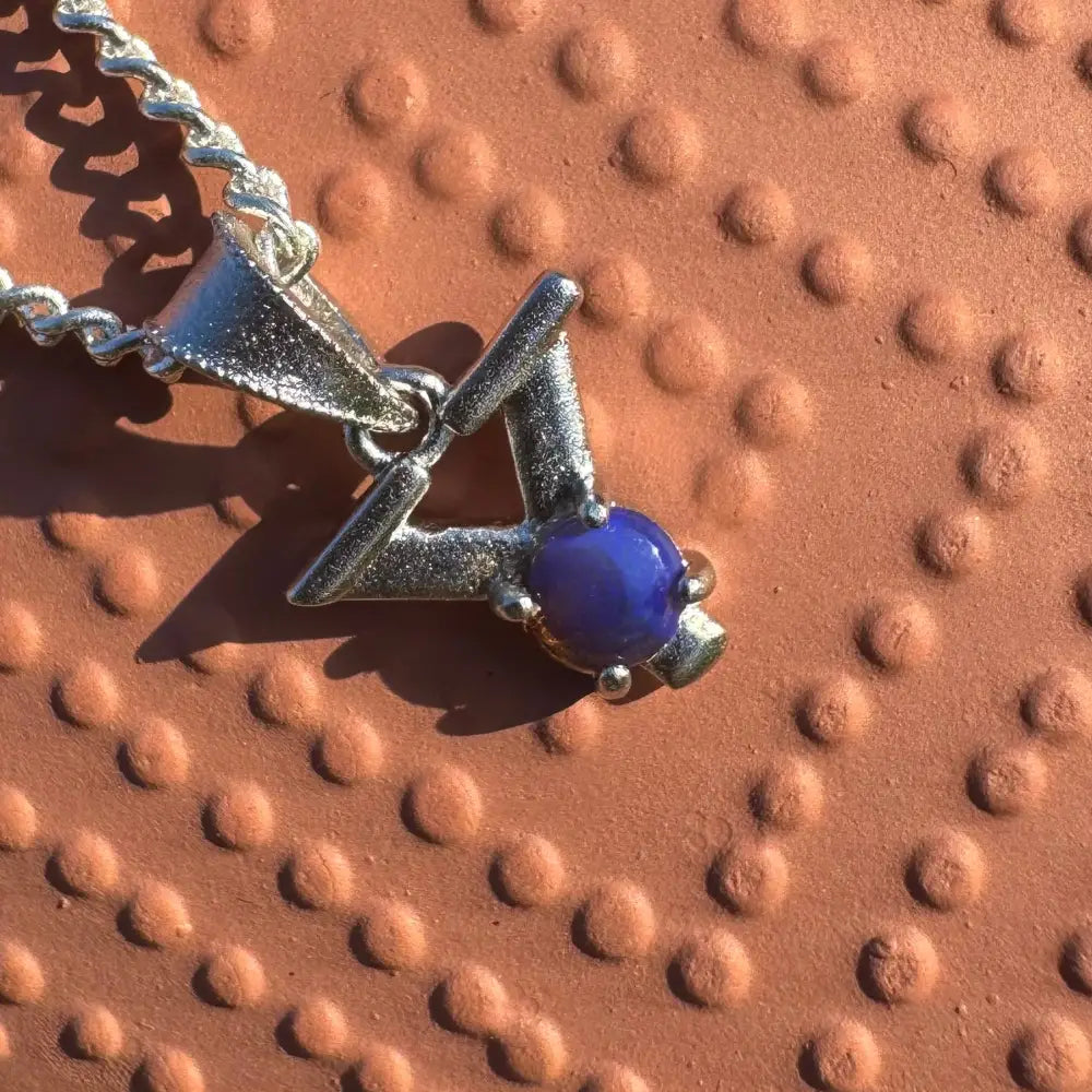 Silver pendant with a vibrant blue Lightning Ridge Opal gemstone in a handcrafted design