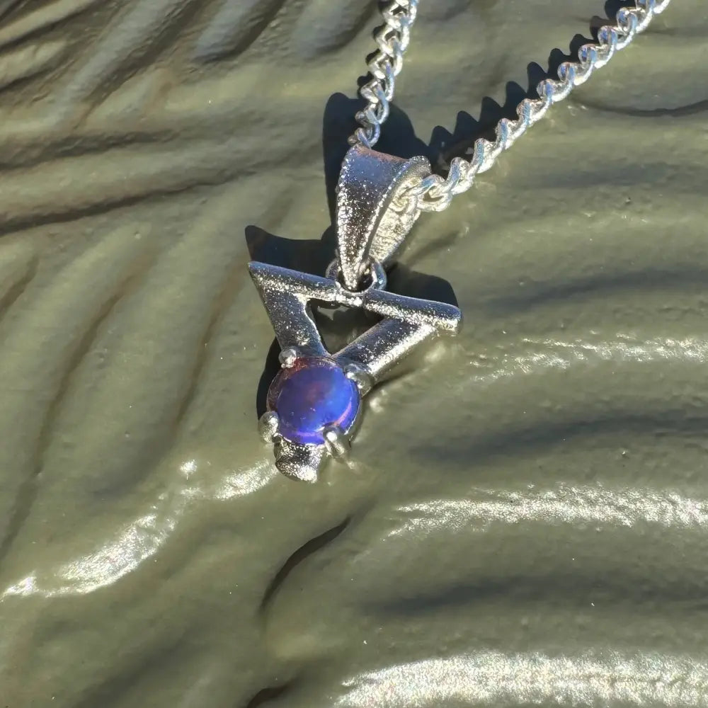 Silver pendant featuring a vibrant blue Lightning Ridge Opal on a sterling silver chain