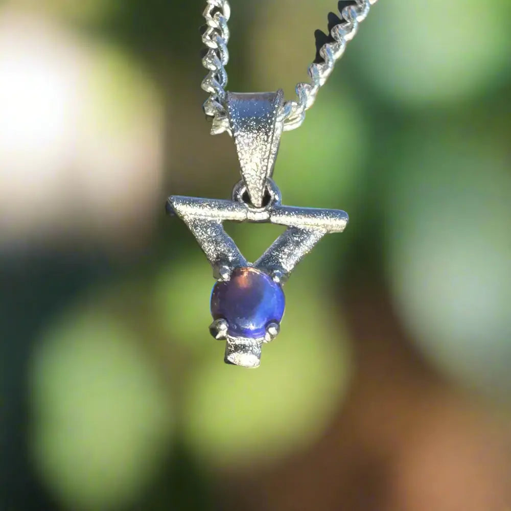 Silver pendant featuring a blue opal with the inscription Your Radiance Necklace