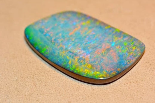 Iridescent Opal Gemstone showcasing vibrant colors in an article about Opal Doublets and Triplets