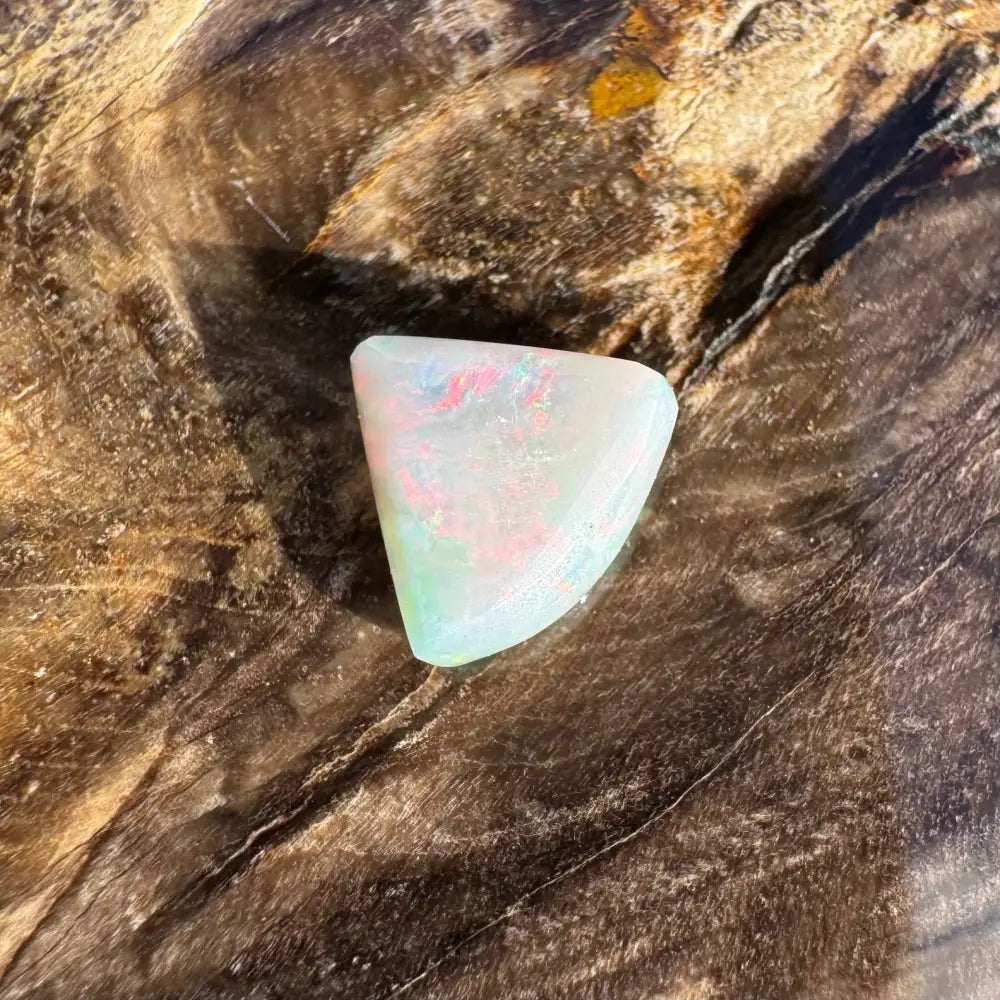 Iridescent triangular opal from Lightning Ridge in the 1.0 carat hand-cut solid opal jewelry